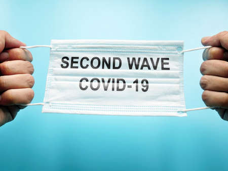 Second wave of covid-19. Hands hold medical mask.の写真素材