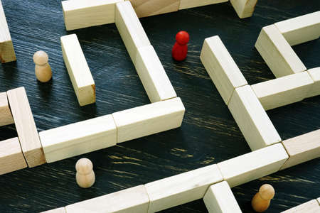 Wooden Labyrinth and figurines inside. Looking for solution of difficult business challenge.の写真素材