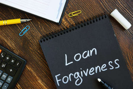 Loan forgiveness note on notepad black page.の写真素材