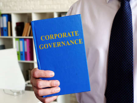 Corporate governance concept. The office clerk shows a book.の写真素材