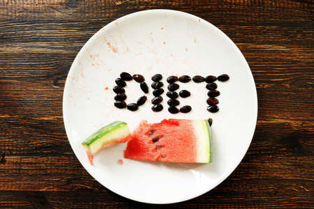 Weight loss and summer diet. A slice of watermelon on a plate.の写真素材