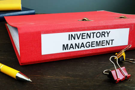 Folder with papers about Inventory Management and yellow pen.の写真素材