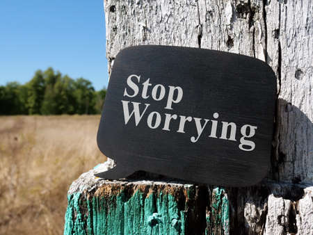 Stop worrying phrase on the black wooden plate.の写真素材