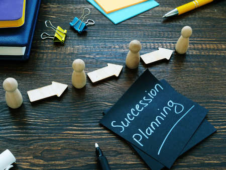Succession planning sign and figurines with arrows.の写真素材