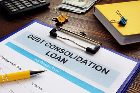 Debt consolidation loan form, notepad and calculator.の写真素材