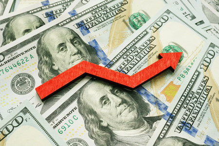 Profit and business growth concept. Stack of money and rising arrow.の写真素材