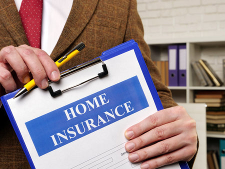 Papers about Home insurance claim and pen for filling out.の写真素材