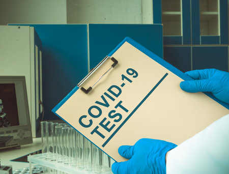 Doctor holds the results of a covid 19 test in the laboratory.の写真素材