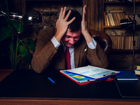A businessman panics because of the crisis, business problems.の写真素材