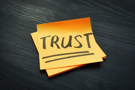 Trust concept. Piece of papers on the dark wooden desk.