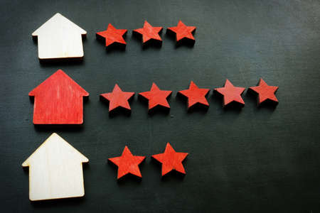 Home appraisal concept. Wooden house and rank five stars.の写真素材