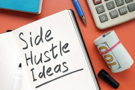 Side hustle ideas list and cash on the desk.の写真素材