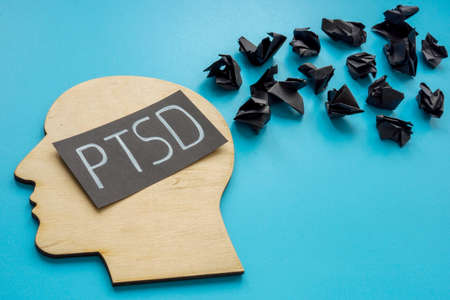 Head shape and word PTSD Post Traumatic Stress Disorder with black paper balls.の写真素材