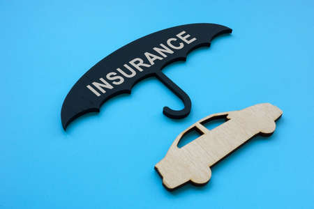 Car insurance concept. Dark umbrella and auto model.の写真素材