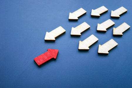 Red arrow to meet other arrows. Stand out from the crowd concept.