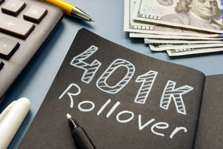 401k rollover memo on the notepad and cash.の写真素材