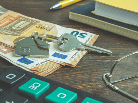 Euros and key for home as symbol money for rent or buying property.の写真素材