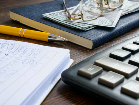 Financial calculations in the notepad, money and calculator.の写真素材