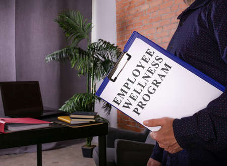 Manager with Employee Wellness Program EWP data in the office.の写真素材