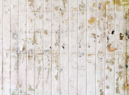Urban background, white ruined industrial wall with creased crumpled placard.の写真素材