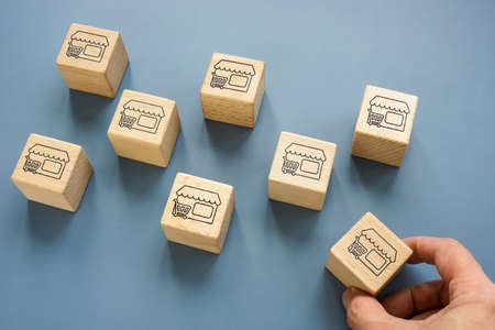 Cubes with shops. Franchise or Merger and Acquisition concept.の写真素材