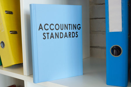 Accounting standards book on the shelf with folders.