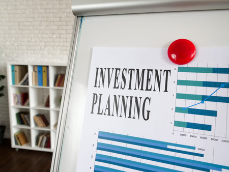Investment planning papers with charts on the whiteboard.