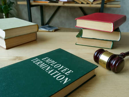 Employee termination rules book and wooden gavel.の写真素材