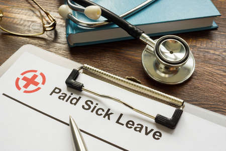 Paid sick leave form and a stethoscope.の写真素材