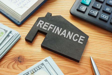 Refinance home mortgage concept. Model of house on the table.の写真素材