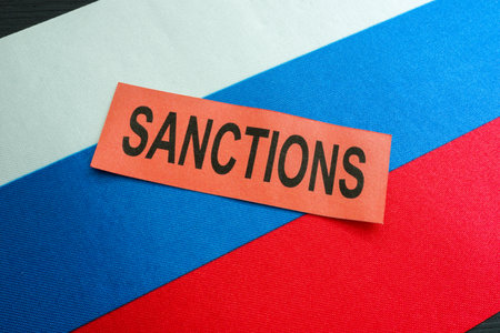Russian flag and word sanctions as symbol of economical restrictions.の写真素材