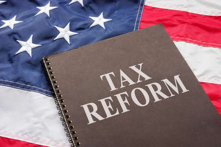 Tax reform documents are on the USA flag.の写真素材