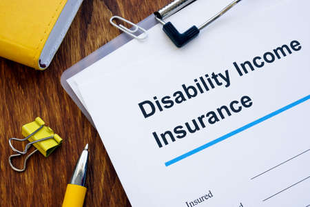 Disability Income DI Insurance application form and pen.の写真素材