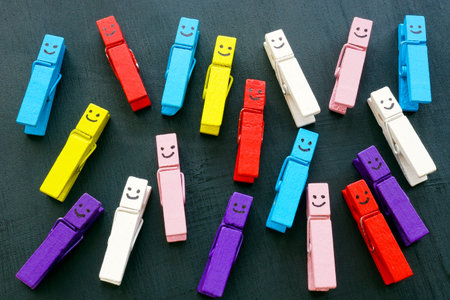 Multicolored clothespins with happy faces. Variety and diversity concept.