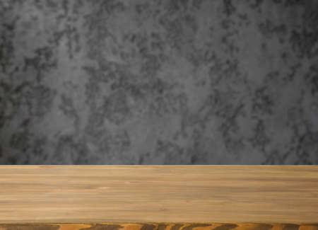 Empty table with free space and blurred grey wall.の写真素材