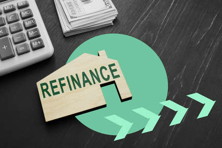Small wooden house with word refinance for mortgage.の写真素材