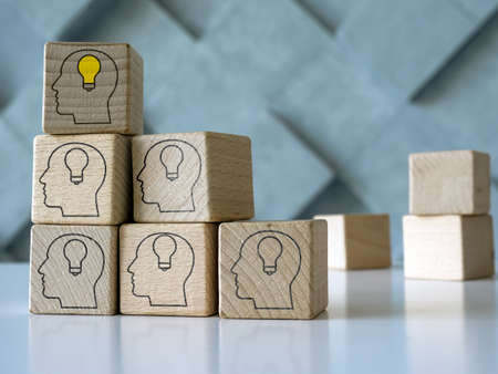 Leadership and new ideas concept. Cubes with head shapes.の写真素材