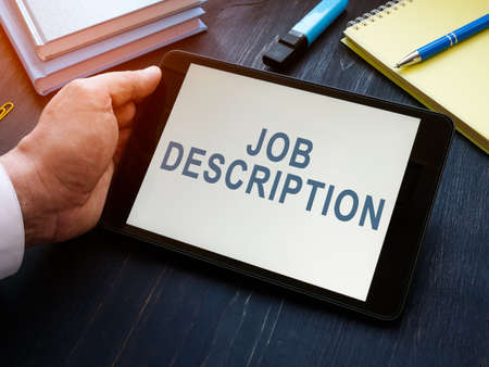 Manager reads Job descriptions on the tablet.の写真素材