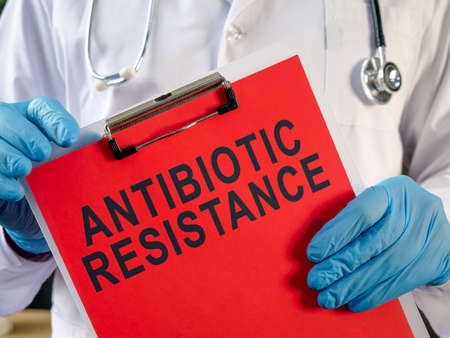 Doctor holding a clipboard with the inscription Antibiotic resistance.の写真素材