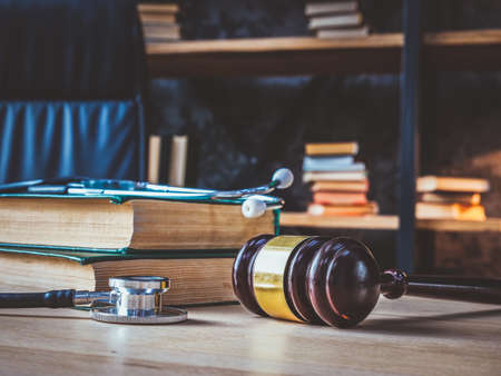 Medical negligence. Stethoscope on the book of laws and a gavel nearby.の写真素材