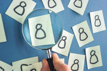 Drawn figure and hand with Magnifying Glass. People recognition concept.の写真素材