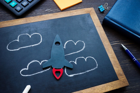 Small rocket and drawn clouds as symbol of dreams and new ideas in business.の写真素材