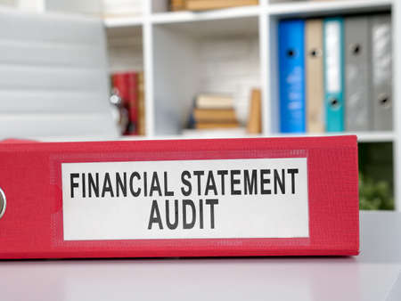 Red folder financial statement audit on the desk.の写真素材