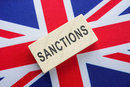 Flag of Great Britain and a block with the inscription Sanctions.