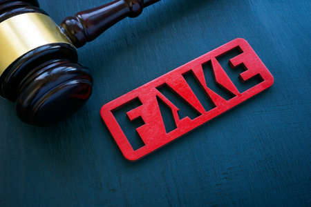 Fake news and punishment concept. Gavel and plate on the surface.の写真素材