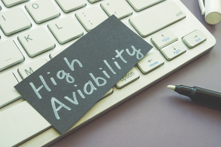 A sheet of paper with words high availability lies on the keyboard.