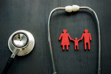Family medicine and health insurance concept. Stethoscope and figurines.の写真素材