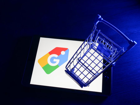 KYIV, UKRAINE - March 30, 2022. Google shopping logo on the screen and shopping cart.のeditorial素材