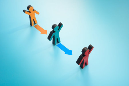 Figurines and colorful arrows. Leadership Transitions concept.の写真素材