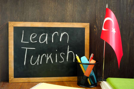 Learn Turkish. A small board and a flag nearby.の写真素材